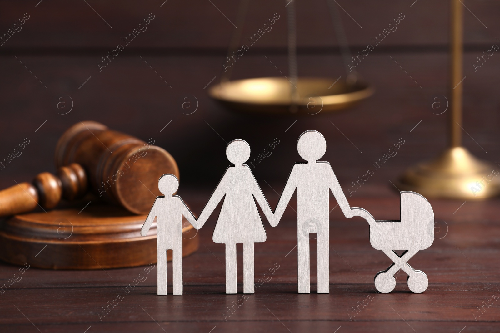 Photo of Family law. Figure of parents with children and gavel on wooden table