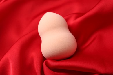 Photo of Makeup sponge on red cloth, above view