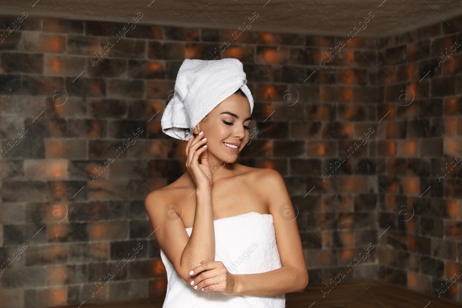 Photo of Portrait of young woman in salt sauna at luxury spa center