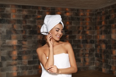 Photo of Portrait of young woman in salt sauna at luxury spa center