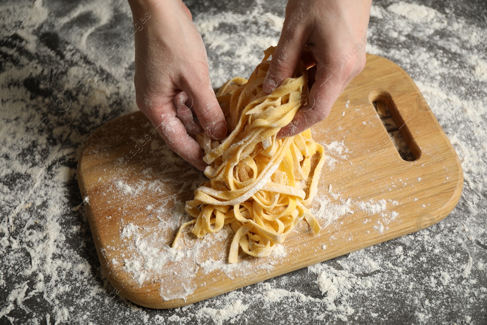 Photo of Woman preparing pasta at table, above view