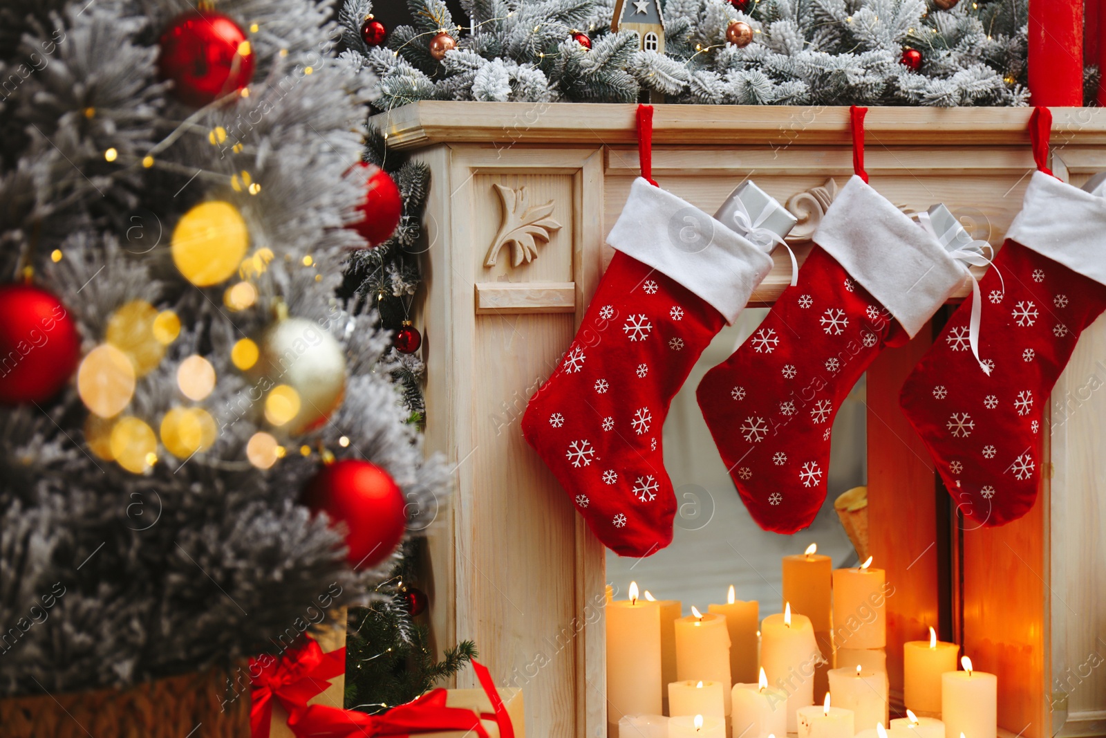 Photo of Fireplace with Christmas stockings in festive room interior