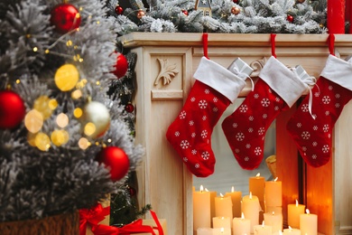 Fireplace with Christmas stockings in festive room interior