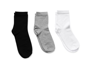 Photo of Different pairs of socks isolated on white, top view