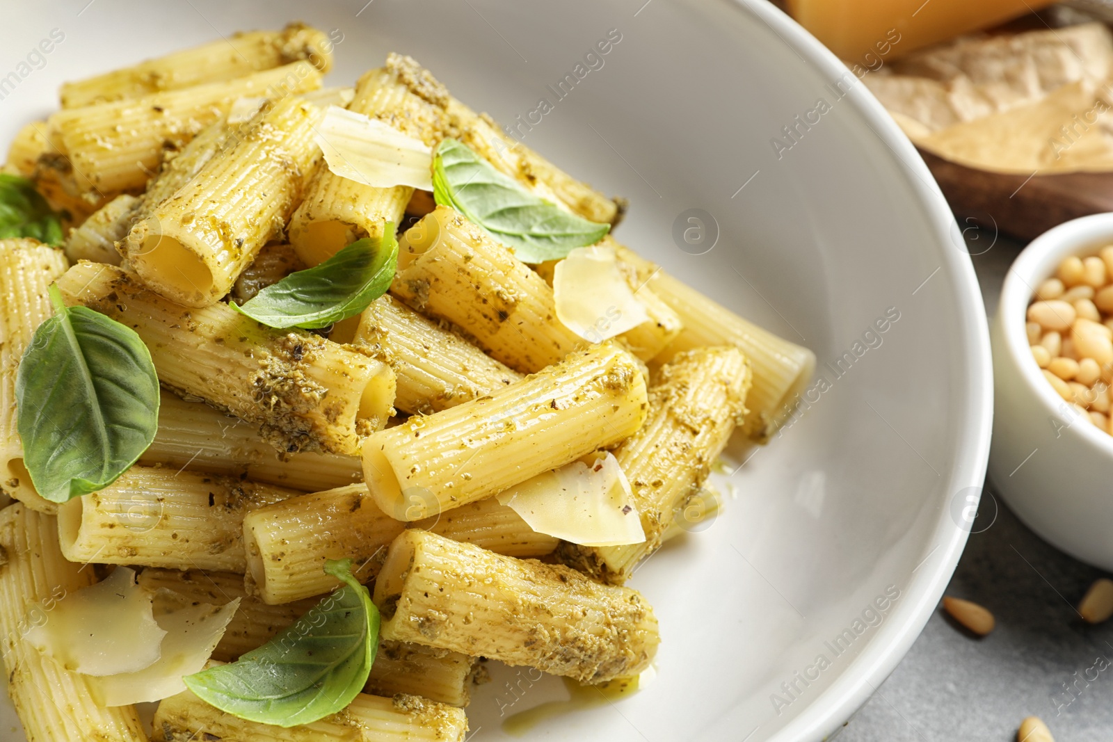 Photo of Delicious basil pesto pasta on plate, closeup