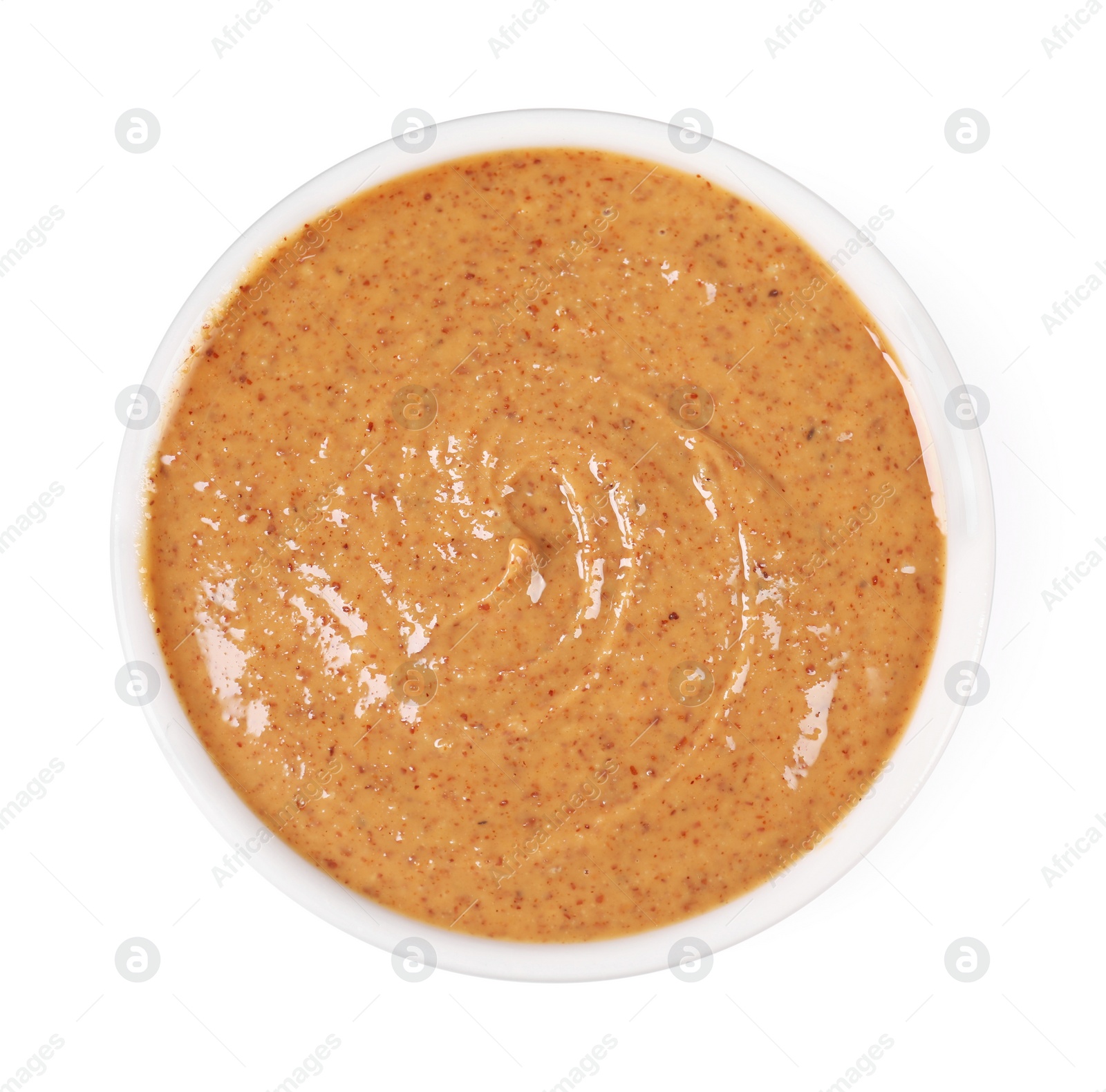 Photo of Delicious nut butter in bowl isolated on white, top view