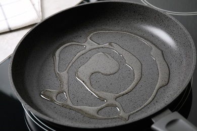 Frying pan with cooking oil on induction stove