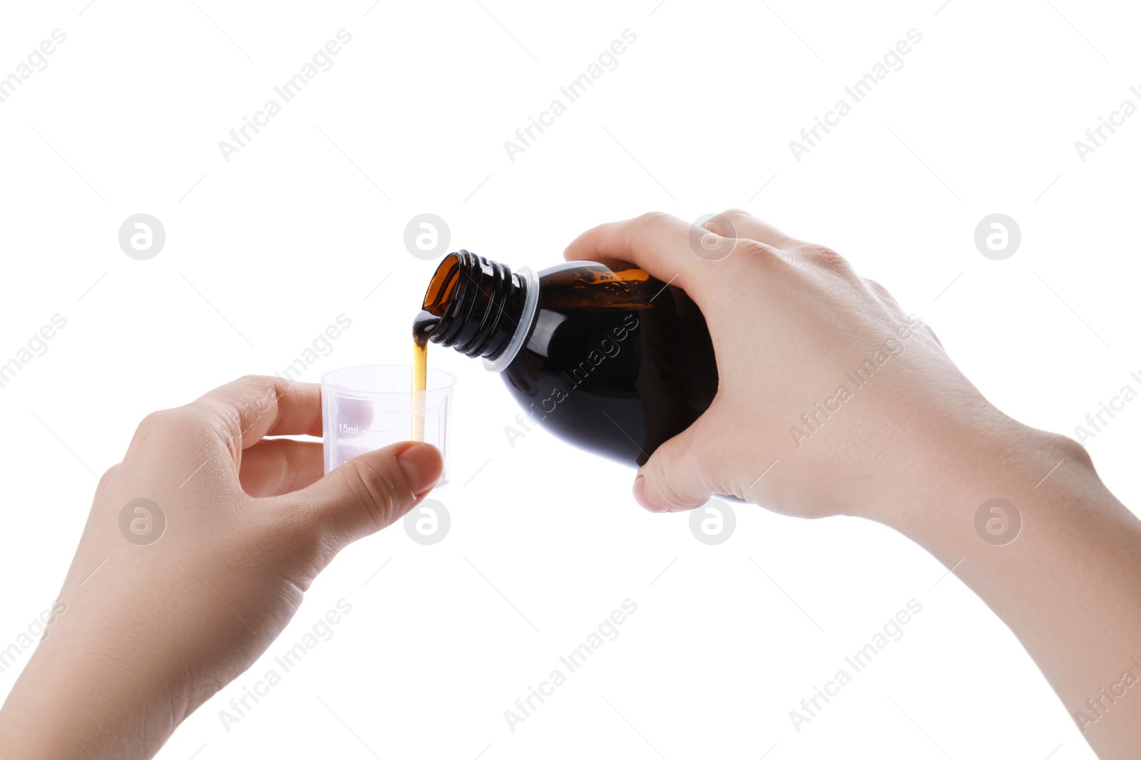 Photo of Woman pouring syrup into measuring cup from bottle isolated on white, closeup. Cough and cold medicine