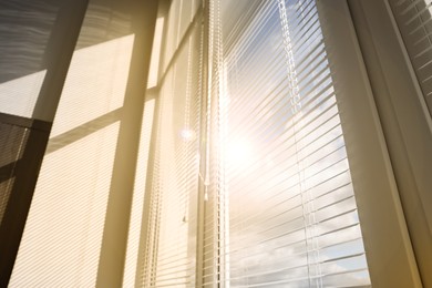 Image of Stylish window with horizontal blinds in room, low angle view