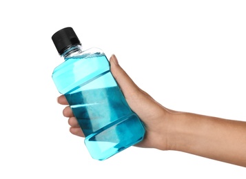 Photo of Woman holding bottle with mouthwash for teeth care on white background