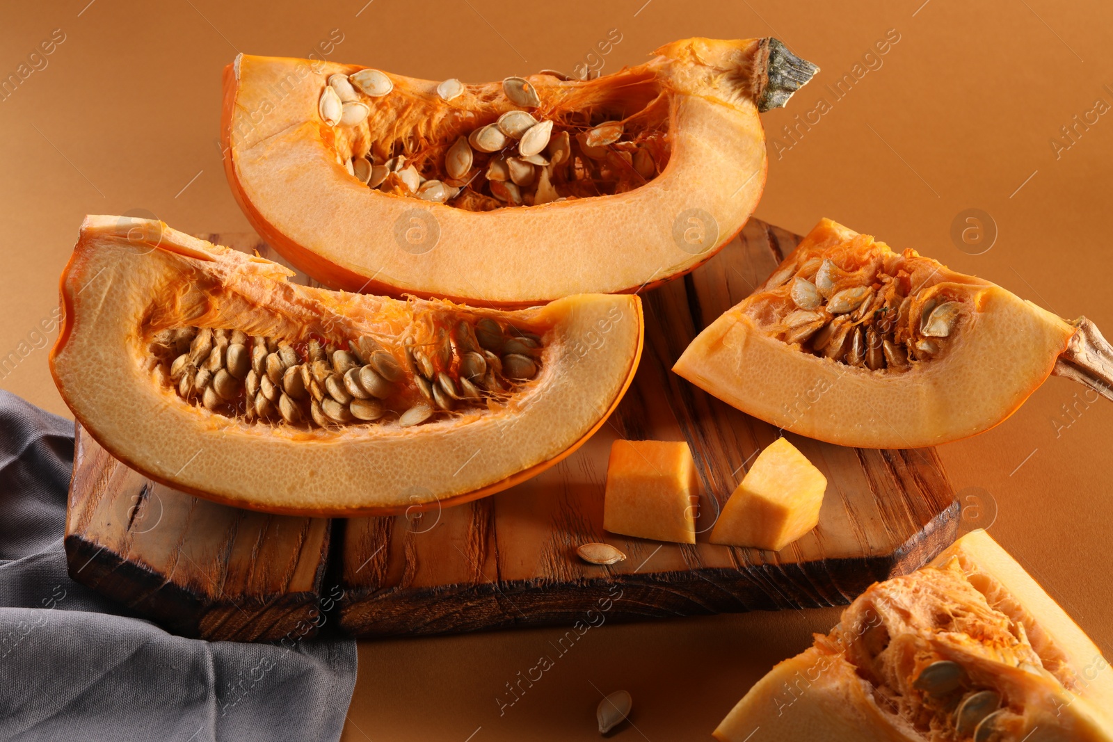 Photo of Cut fresh ripe pumpkin on orange background, closeup