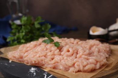 Photo of Fresh raw minced meat on wooden table, closeup