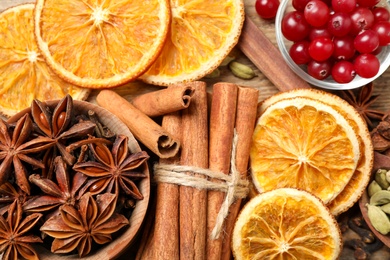 Photo of Flat lay composition with mulled wine ingredients on wooden table, top view