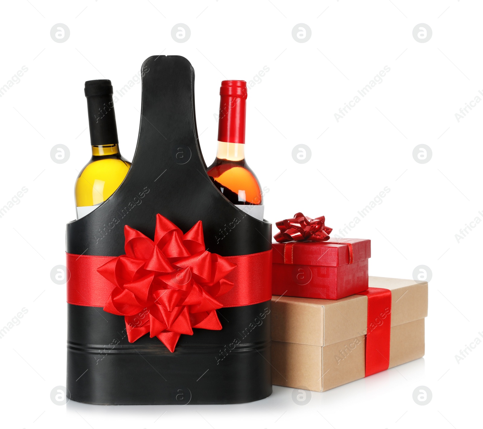 Photo of Wine bottles in festive package with red bow and gift boxes isolated on white