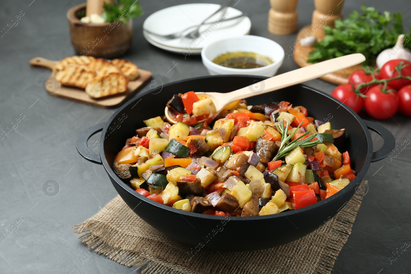 Photo of Delicious ratatouille served on grey table, closeup