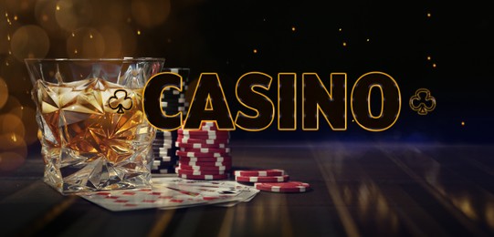 Illustration of Word Casino, chips, playing cards and glass of whiskey on wooden table, bokeh effect. Banner design