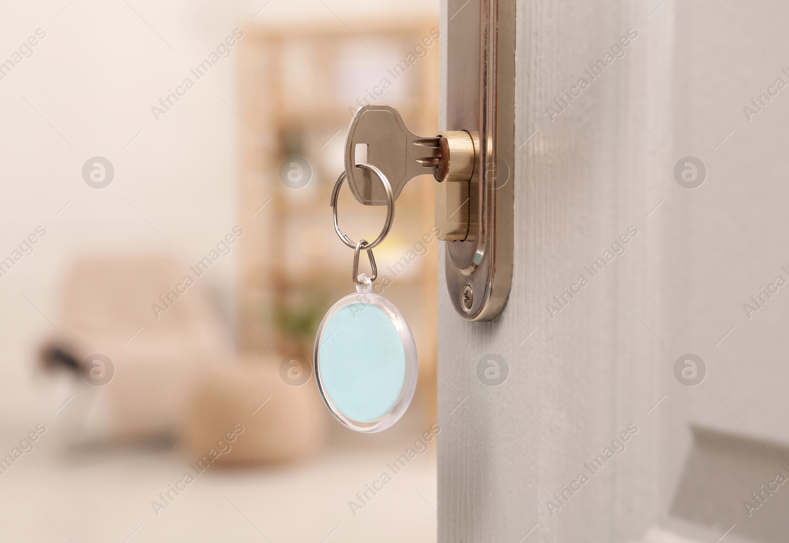 Photo of Open door with key in room, closeup