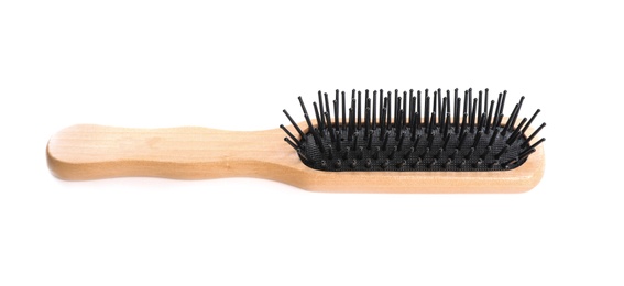 Photo of New wooden hair brush on white background