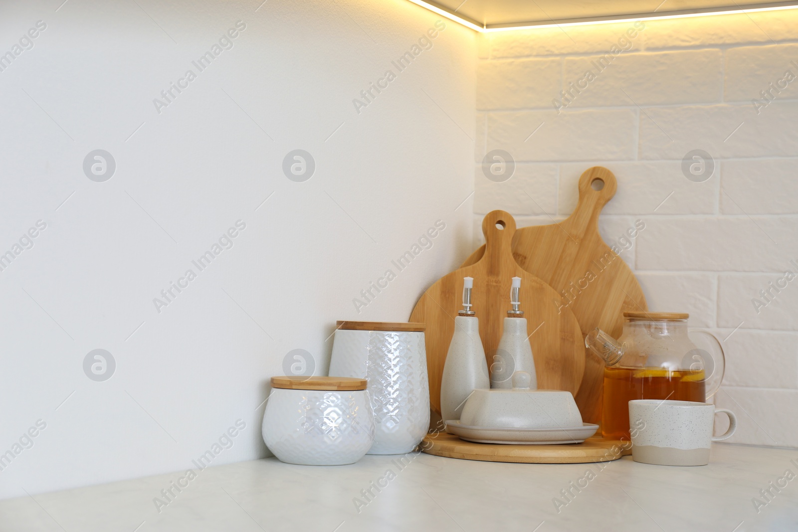 Photo of Wooden boards and different kitchen items on countertop indoors