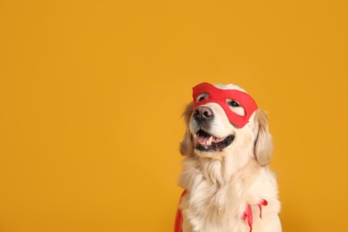 Adorable dog in red superhero cape and mask on yellow background, space for text