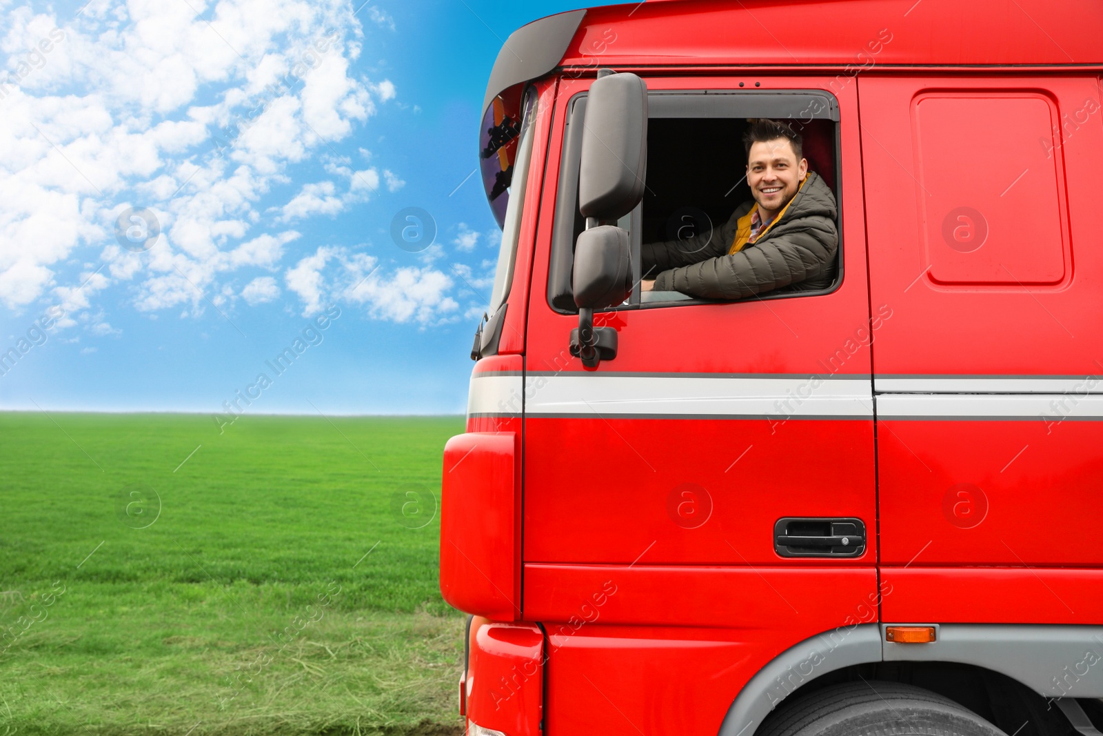 Photo of Portrait of happy driver in cab of modern truck