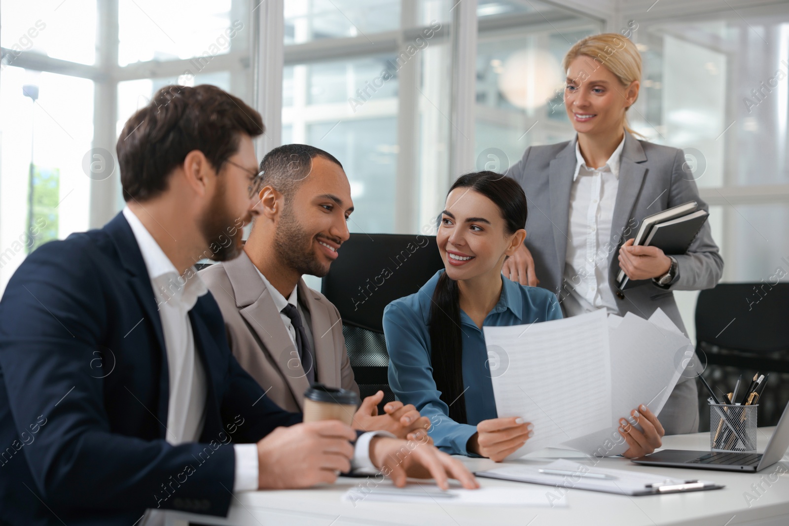 Photo of Lawyers working together at table in office