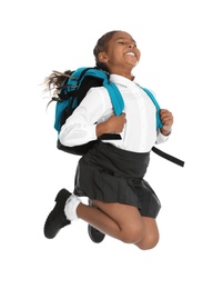 Happy African-American girl in school uniform jumping on white background