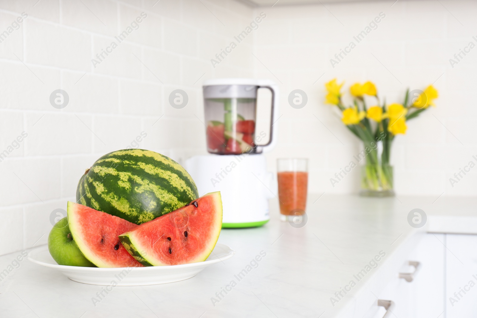 Photo of Blender and smoothie ingredients on counter in kitchen