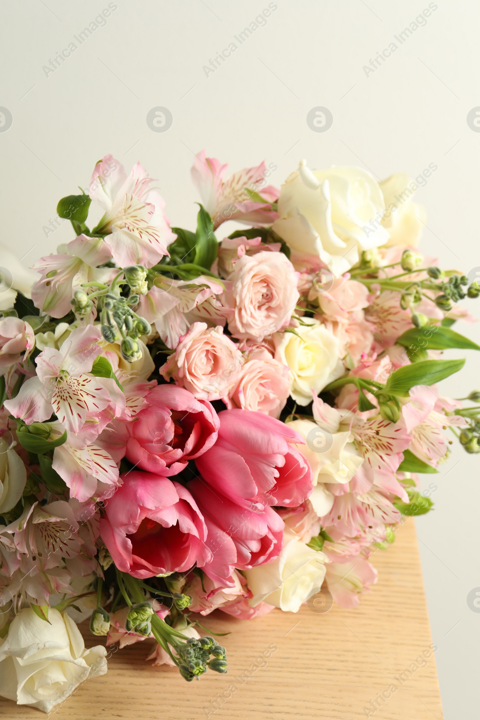 Photo of Beautiful bouquet of fresh flowers on wooden table, closeup
