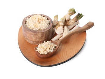 Board with grated horseradish, cut roots and spoon isolated on white