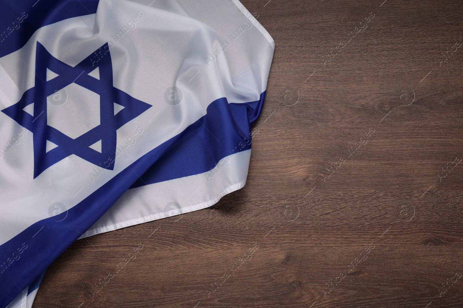 Photo of Flag of Israel on wooden background, top view and space for text. National symbol