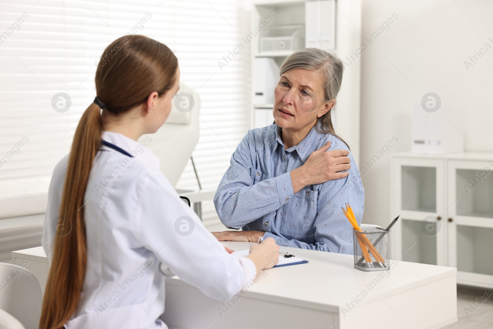 Photo of Arthritis symptoms. Doctor consulting patient with shoulder pain in hospital