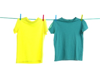 Child clothes on laundry line against white background