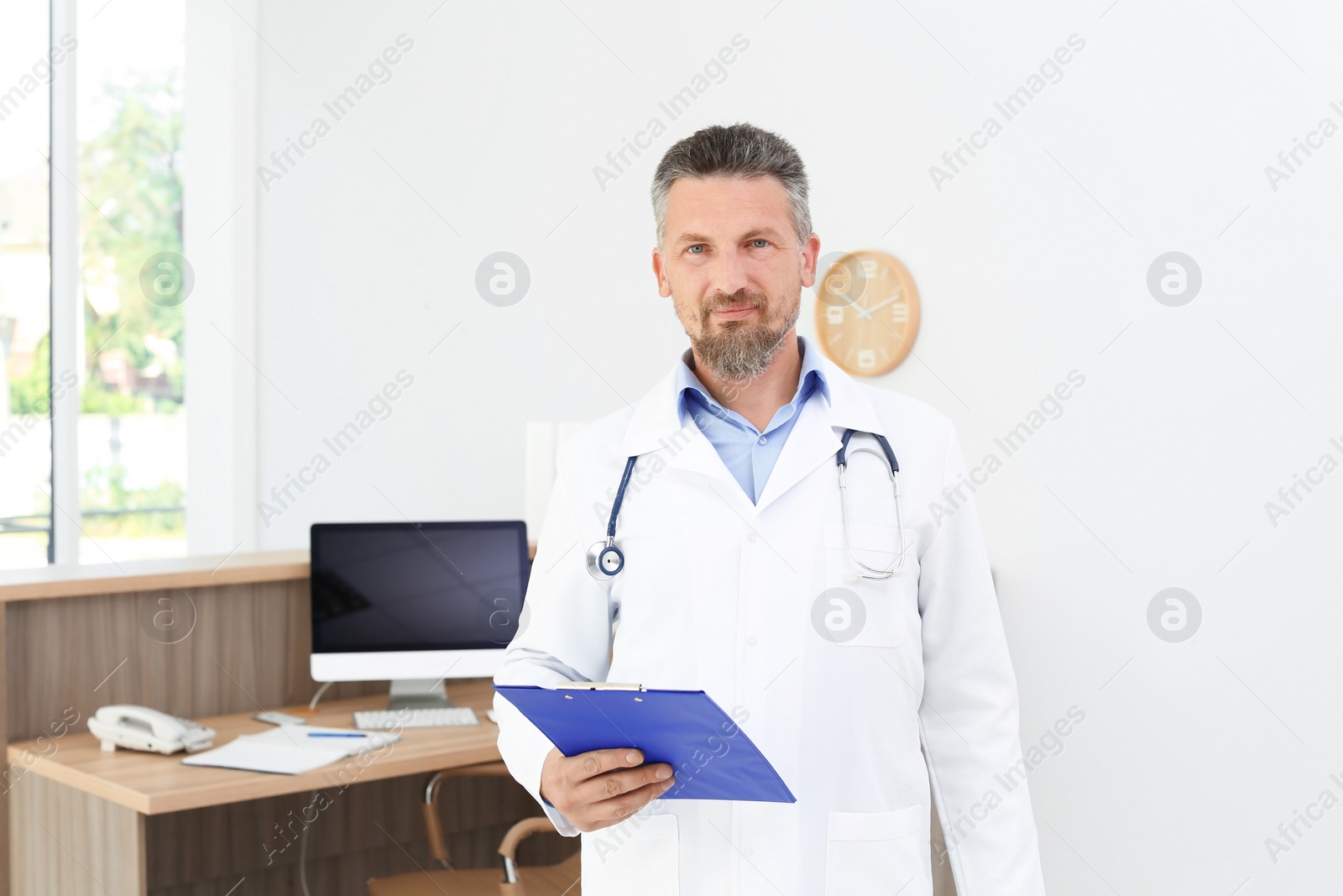 Photo of Male medical assistant near workplace in clinic. Health care service