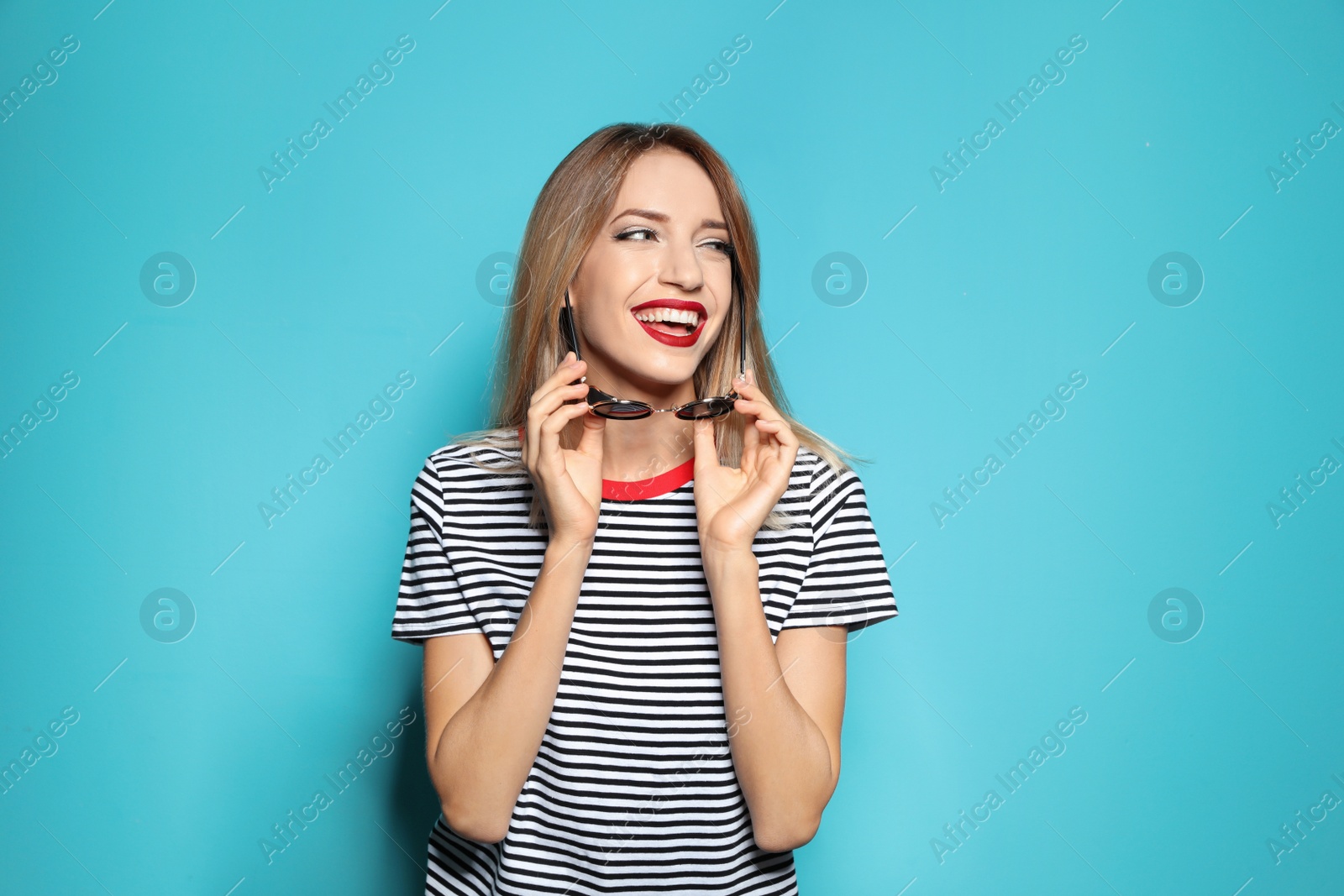 Photo of Beautiful young woman with healthy long blonde hair on color background