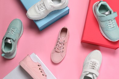 Photo of Flat lay composition with different stylish sports shoes on pink background