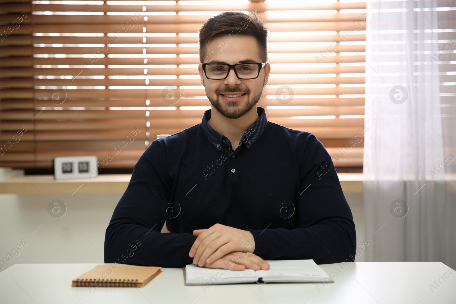 Photo of Happy man using video chat in modern office, view from web camera