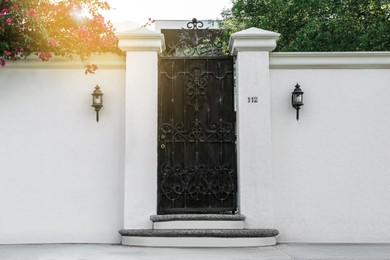 Entrance of house with ornate metal door