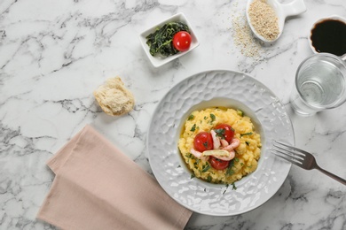 Photo of Plate with fresh tasty shrimp and grits on table