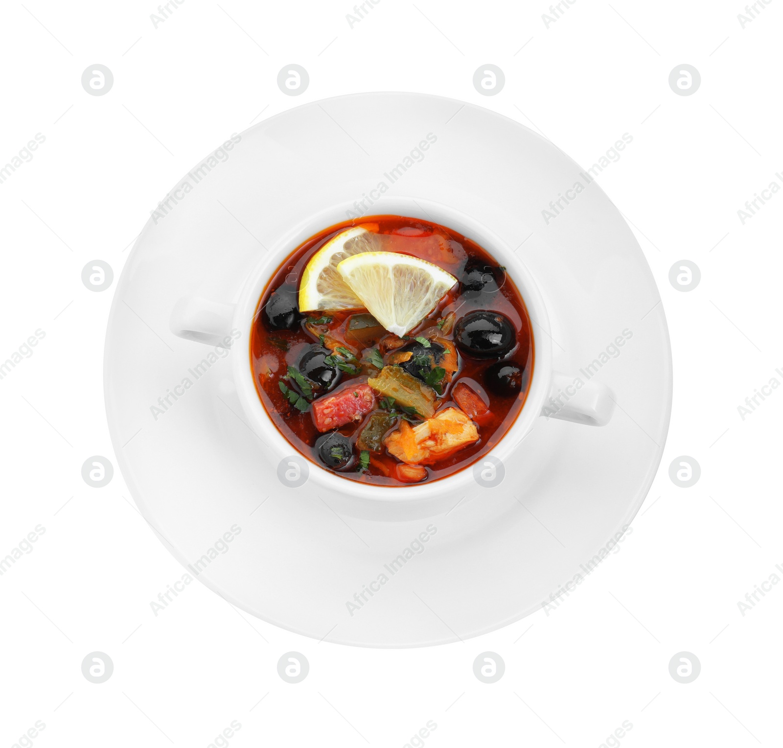 Photo of Meat solyanka soup with sausages, olives and vegetables in bowl isolated on white, top view