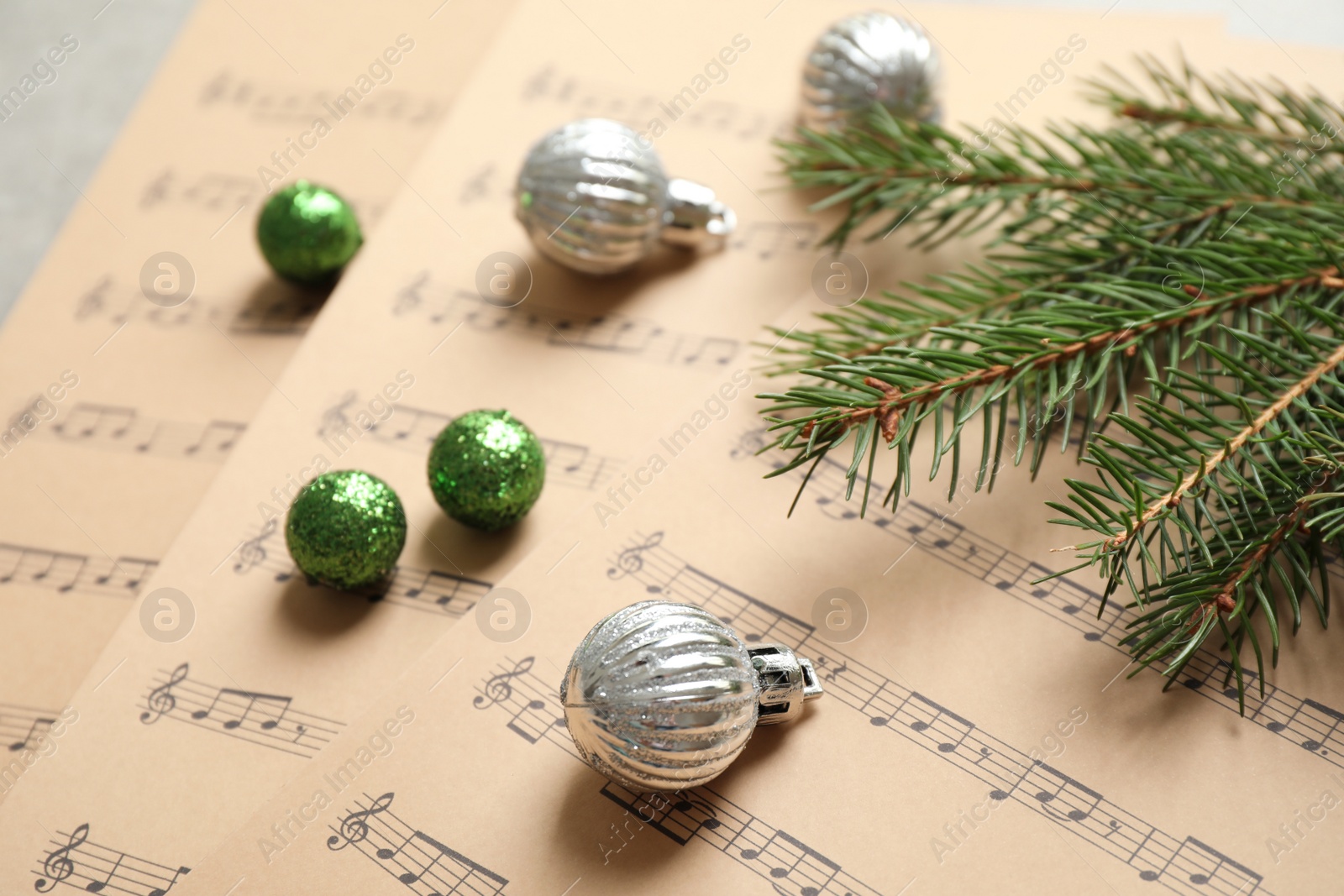 Photo of Christmas decorations on music sheets, closeup view
