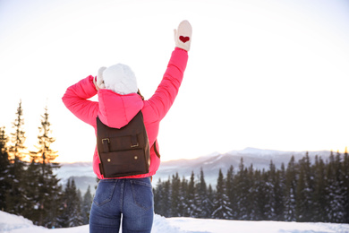 Young woman outdoors, space for text. Winter vacation