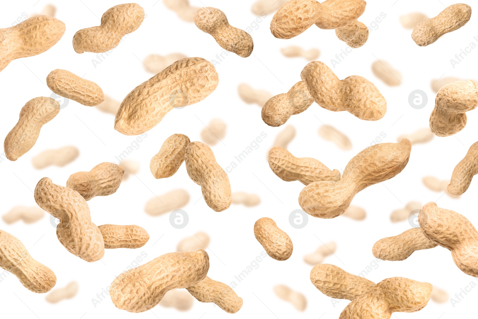 Image of Unpeeled peanuts in air on white background