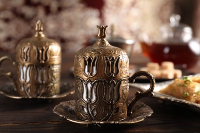 Photo of Traditional Turkish tea served in vintage tea set on wooden table