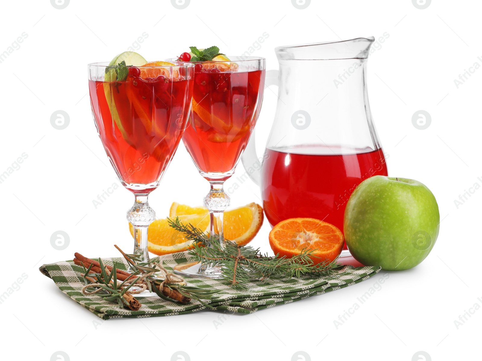 Photo of Christmas Sangria cocktail in glasses and jug, ingredients and fir tree branch isolated on white