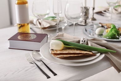 Photo of Festive Passover table setting with Torah. Pesach celebration
