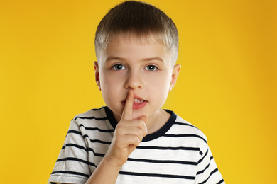 Photo of Portrait of little boy on yellow background