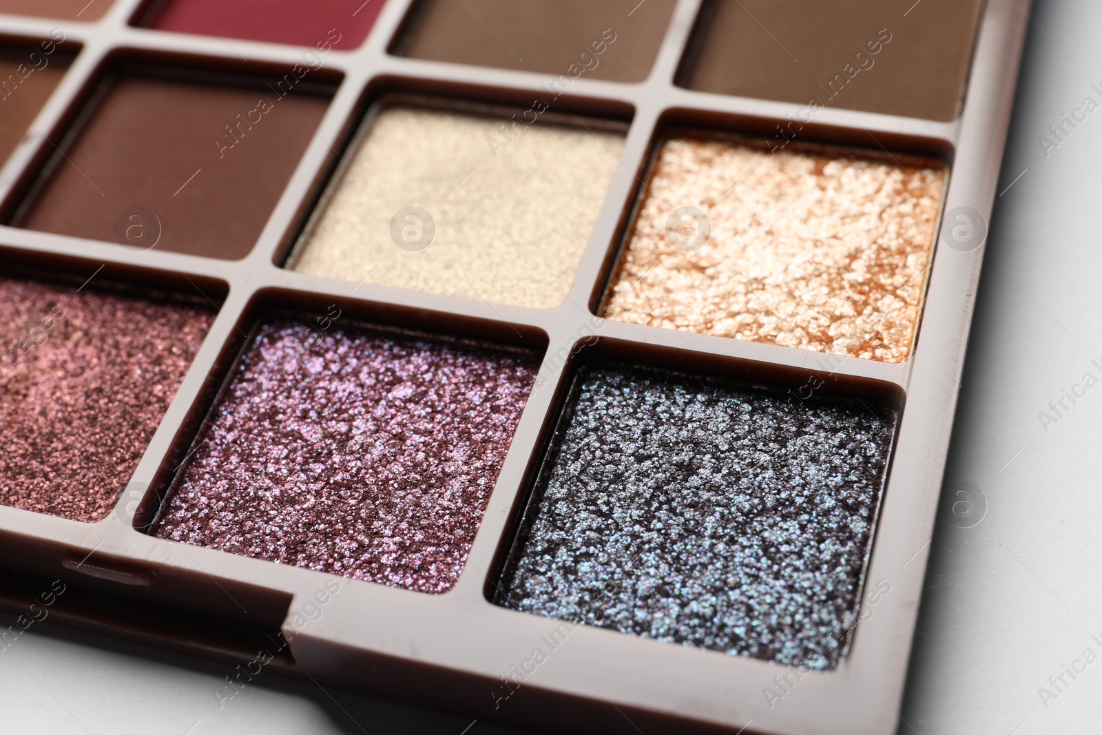 Photo of Beautiful eye shadow palette on white table, closeup