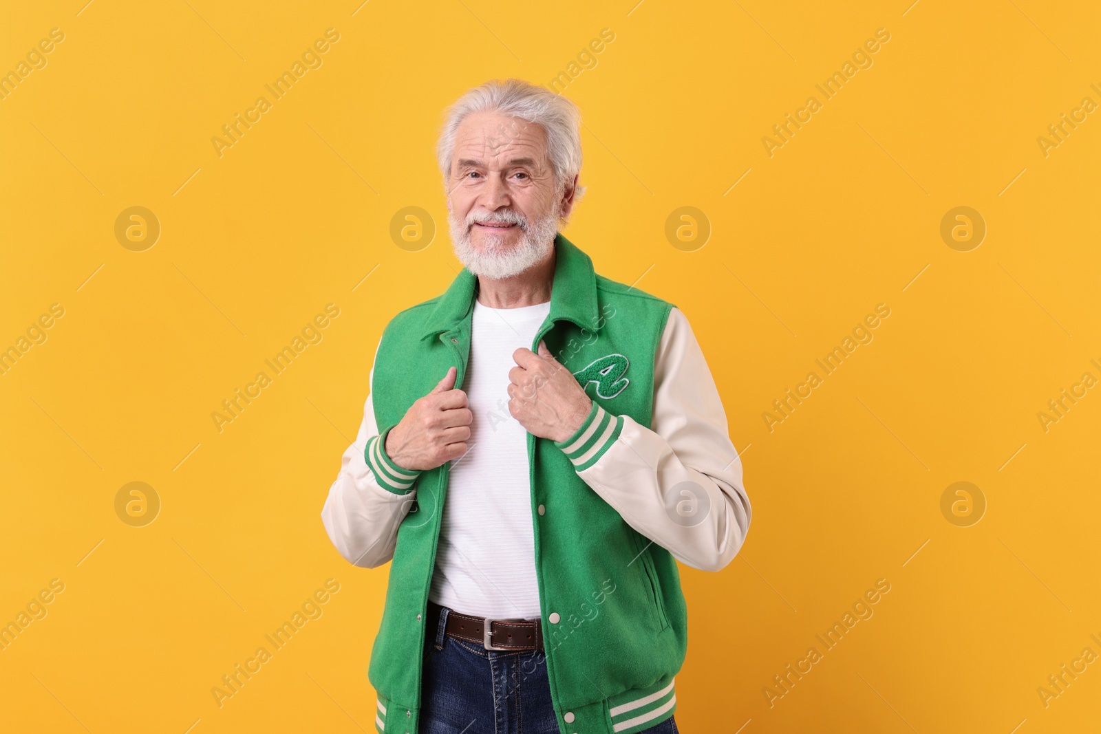 Photo of Portrait of stylish grandpa on yellow background