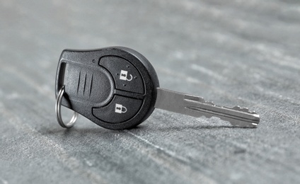 New modern car key on grey background